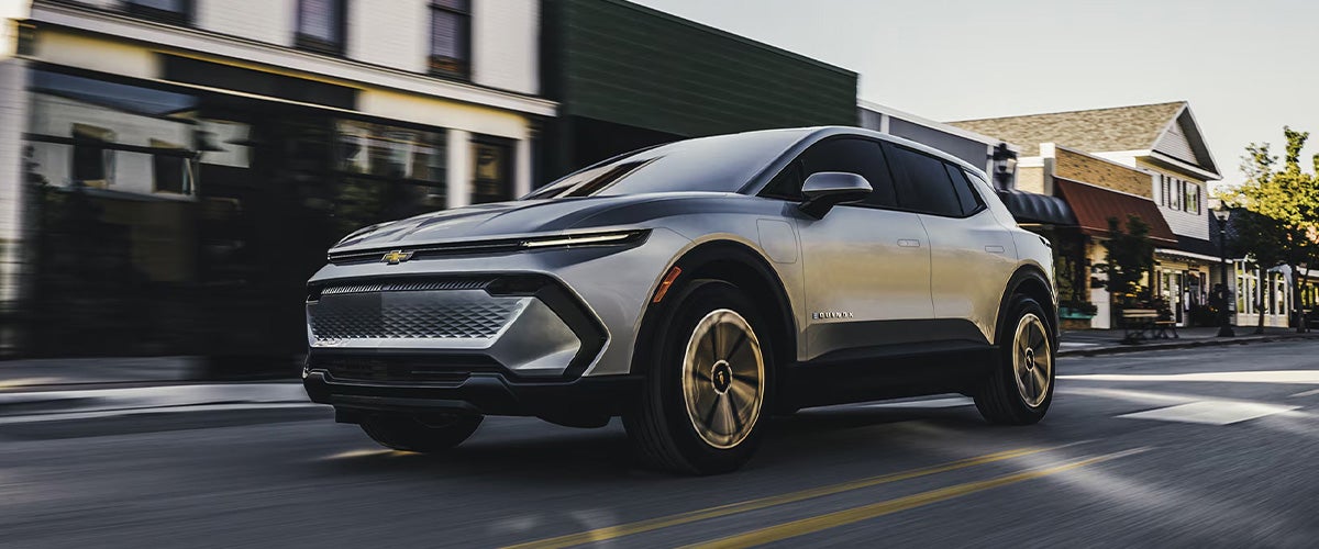 Silver Chevrolet SUV driving on the city streets