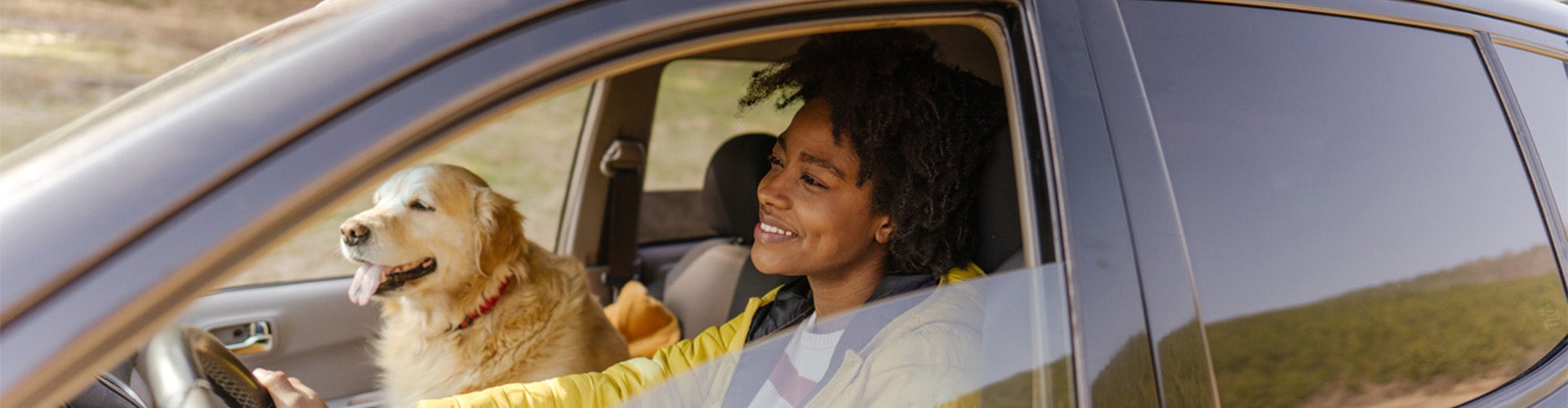 Customer driving with her dog in her new car
